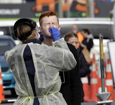 New Zealand to roll back social distancing restrictions